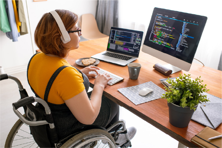 Photo of a young woman coding on a computer.